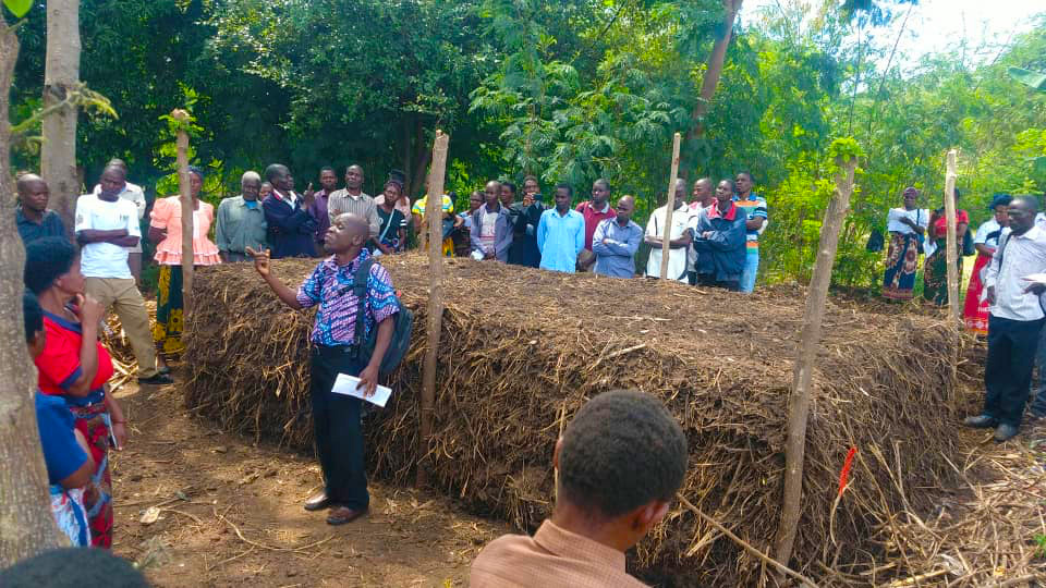 Gracious, our farm manager, teaching the community farmers about the benefits of composting.